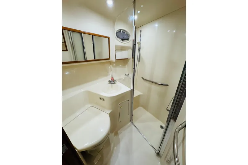 Slide: The Image of Bathroom interior of 1999 Sea Ray 400 Sedan Bridge yacht, featuring shower and sink. - 82