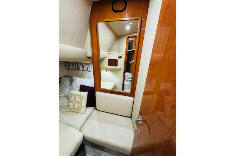 Slide: The Image of Interior of 1999 Sea Ray 400 Sedan Bridge with cozy seating and mirror. - 85
