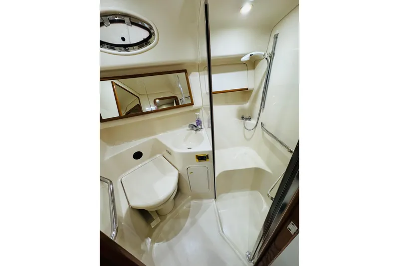 Slide: The Image of Bathroom interior of 1999 Sea Ray 400 Sedan Bridge yacht, featuring shower and sink. - 86
