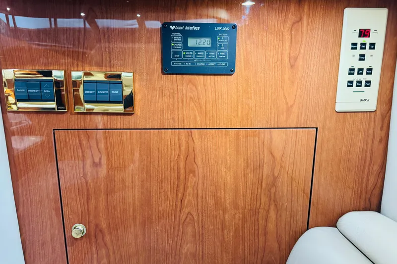 Slide: The Image of Control panel on 1999 Sea Ray 400 Sedan Bridge yacht with wood finish and digital displays. - 87