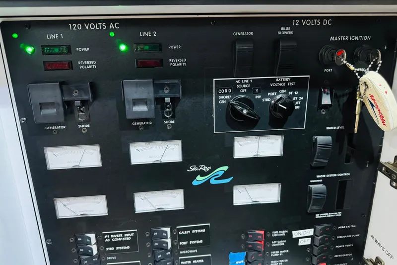 Slide: The Image of Control panel of a 1999 Sea Ray 400 Sedan Bridge boat, featuring electrical switches and gauges. - 88