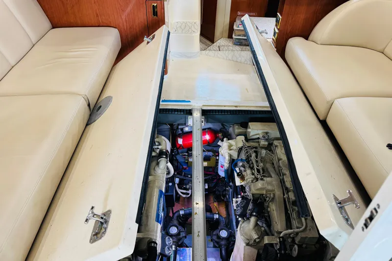 Slide: The Image of Engine compartment of a 1999 Sea Ray 400 Sedan Bridge yacht, showcasing mechanical components. - 91