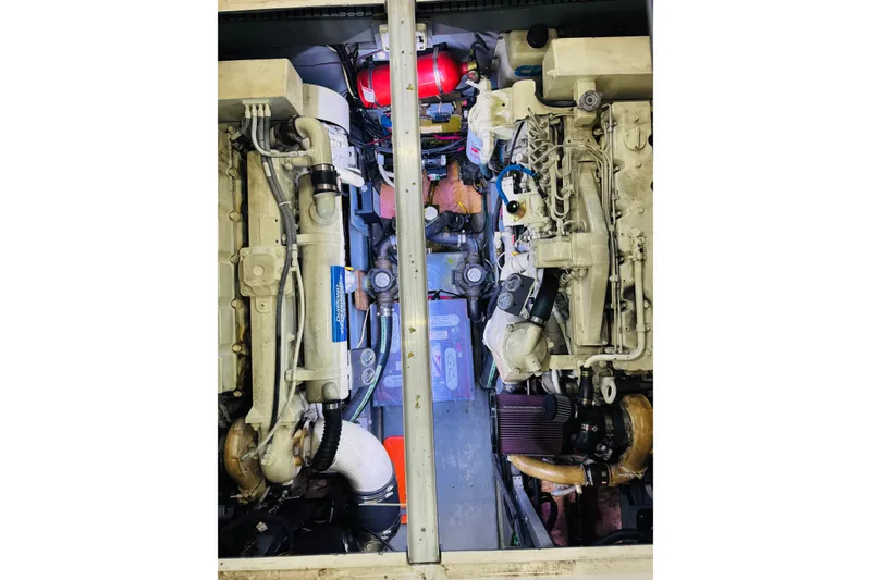 Slide: The Image of Engine compartment of a 1999 Sea Ray 400 Sedan Bridge boat, showcasing dual engines. - 92