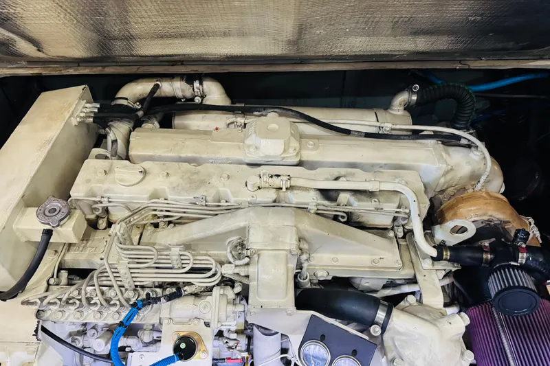 Slide: The Image of Engine compartment of a 1999 Sea Ray 400 Sedan Bridge boat, showcasing mechanical components. - 94