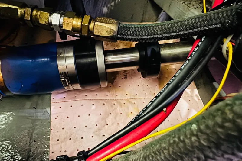 Slide: The Image of Engine compartment of a 1999 Sea Ray 400 Sedan Bridge with visible cables and components. - 97