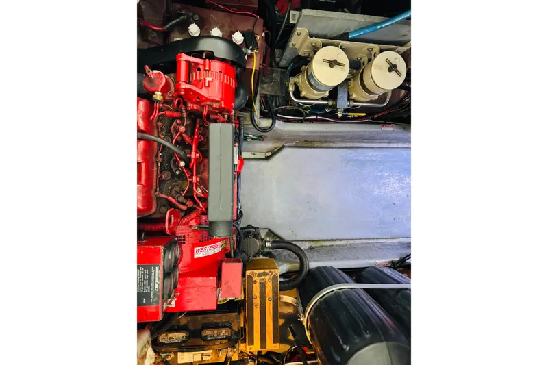 Slide: The Image of Engine compartment of a 1999 Sea Ray 400 Sedan Bridge with visible components. - 98