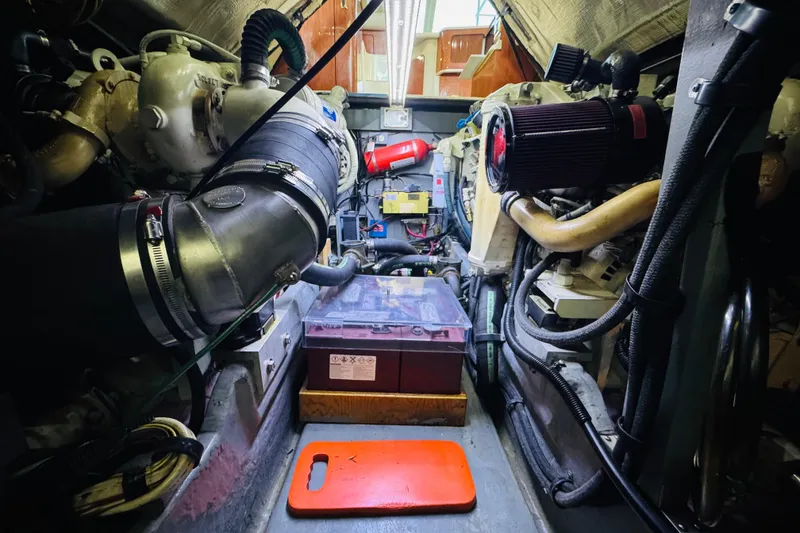 Slide: The Image of Engine room of a 1999 Sea Ray 400 Sedan Bridge, showcasing mechanical components. - 99