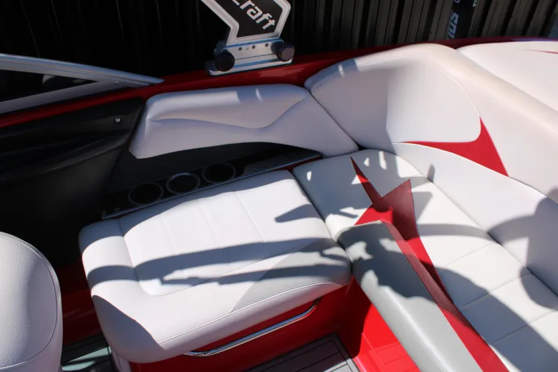 Slide: The Image of 2007 MasterCraft X2 boat interior with white and red seating, cup holders, and sleek design. - 12