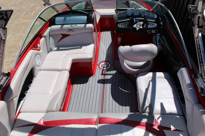 Slide: The Image of 2007 MasterCraft X2 boat interior with red and white seating, sleek dashboard, and modern design. - 8