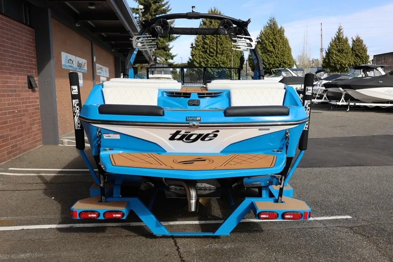 Slide: The Image of 2022 Tigé Z3 boat in vibrant blue, parked outdoors, showcasing rear design and features. - 11