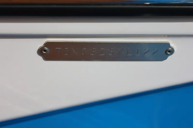 Slide: The Image of 2022 Tigé Z3 boat hull identification number plate on white and blue surface. - 13