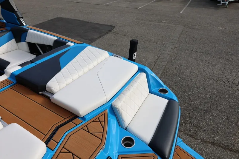Slide: The Image of 2022 Tigé Z3 boat interior with blue and white cushioned seating and wood accents. - 17