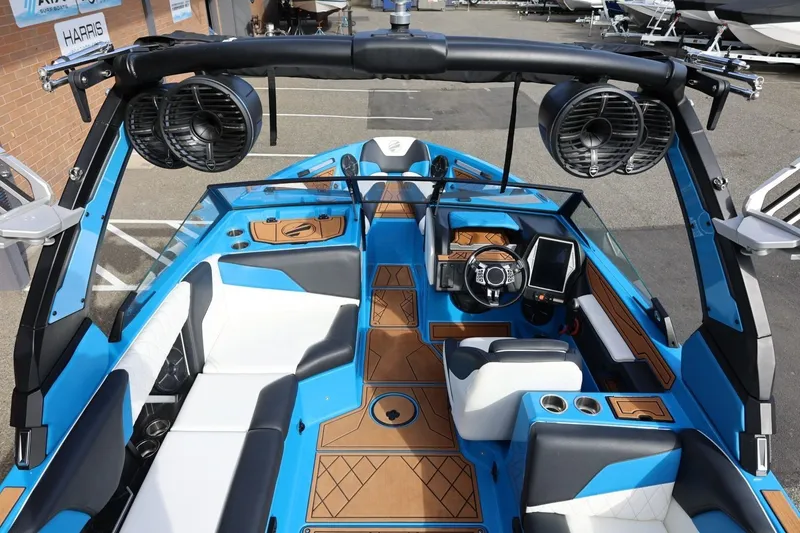Slide: The Image of 2022 Tigé Z3 boat interior with blue accents, luxury seating, and advanced dashboard controls. - 23