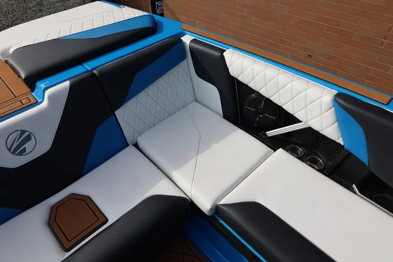 Slide: The Image of 2022 Tigé Z3 boat interior with blue, black, and white seating, featuring quilted design. - 26