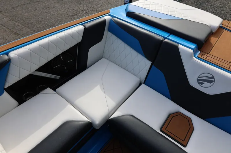 Slide: The Image of 2022 Tigé Z3 boat interior with blue and white cushioned seating. - 28
