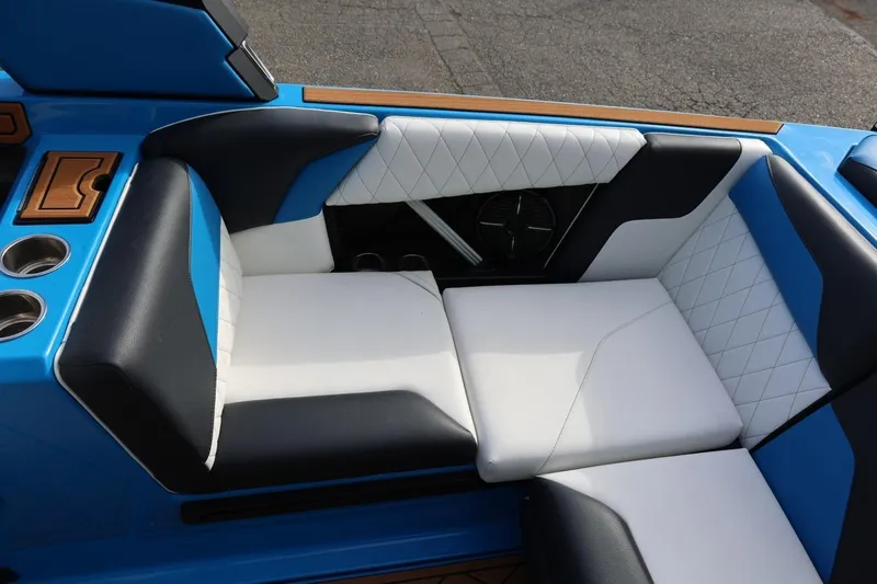 Slide: The Image of 2022 Tigé Z3 boat interior with blue and white cushioned seating. - 29