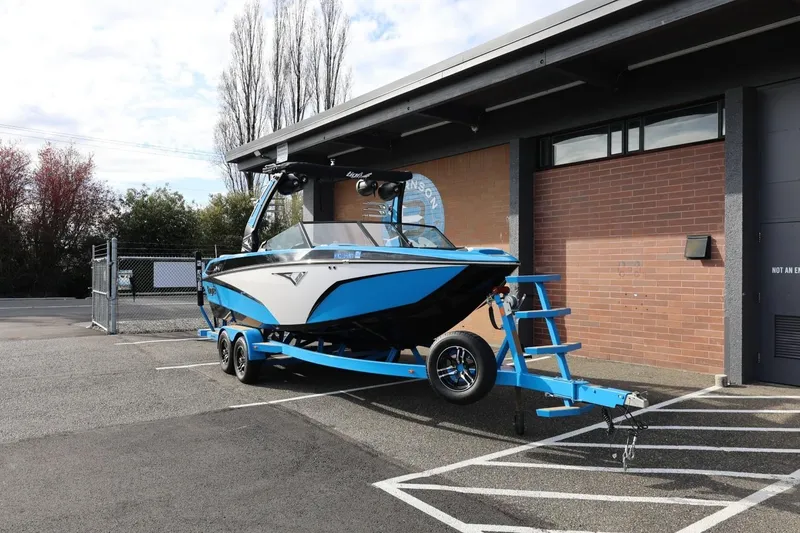 Slide: The Image of 2022 Tigé Z3 boat on trailer parked outside a building. - 3