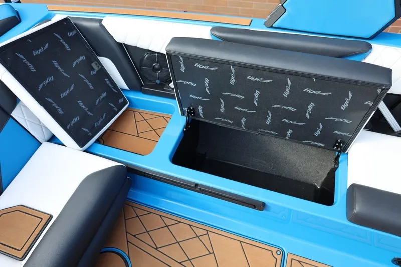 Slide: The Image of 2022 Tigé Z3 boat interior with open storage compartments and blue-white seating. - 31