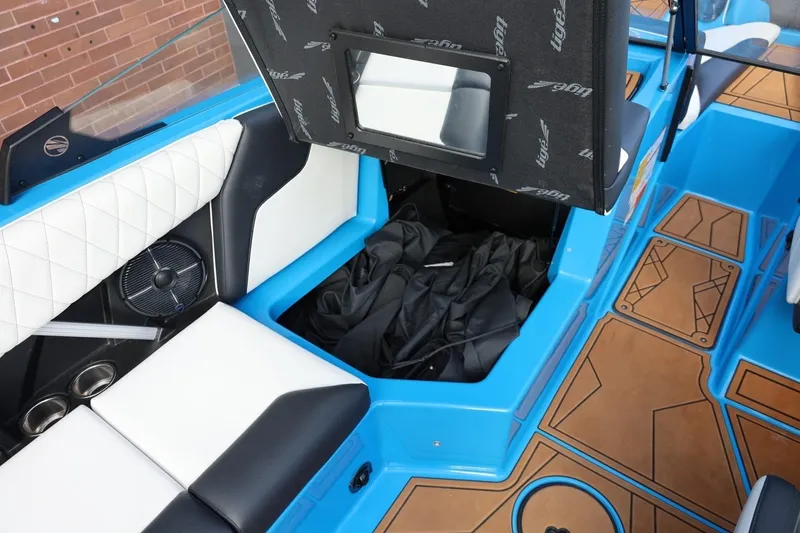 Slide: The Image of 2022 Tigé Z3 boat interior with blue accents, storage compartment, and stylish seating. - 32