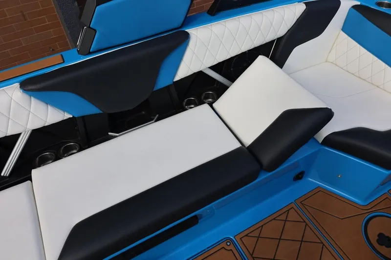 Slide: The Image of 2022 Tigé Z3 boat interior with blue and white cushioned seating. - 33