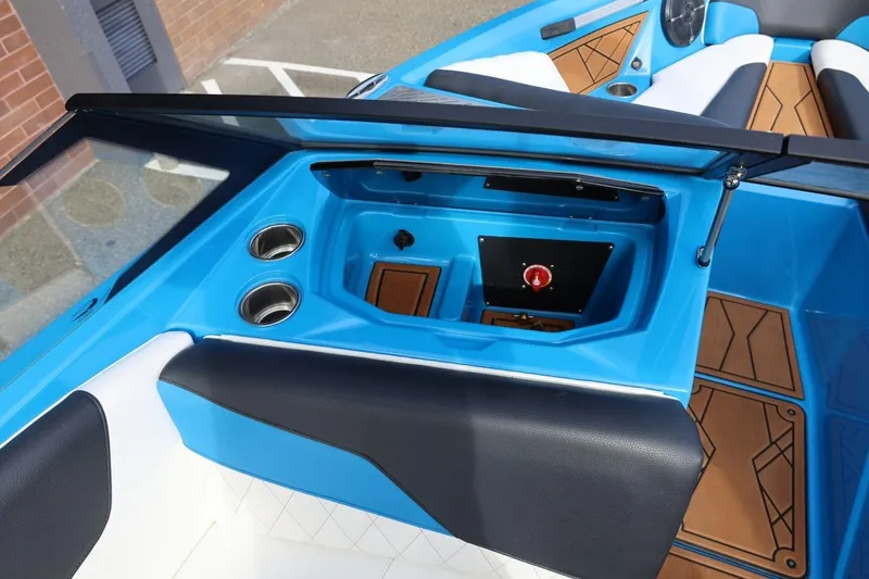 Slide: The Image of 2022 Tigé Z3 boat interior with blue accents and cup holders. - 35