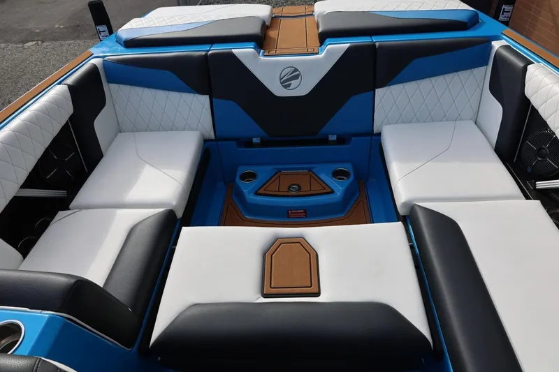 Slide: The Image of 2022 Tigé Z3 boat interior with blue, white, and black seating and wood accents. - 41