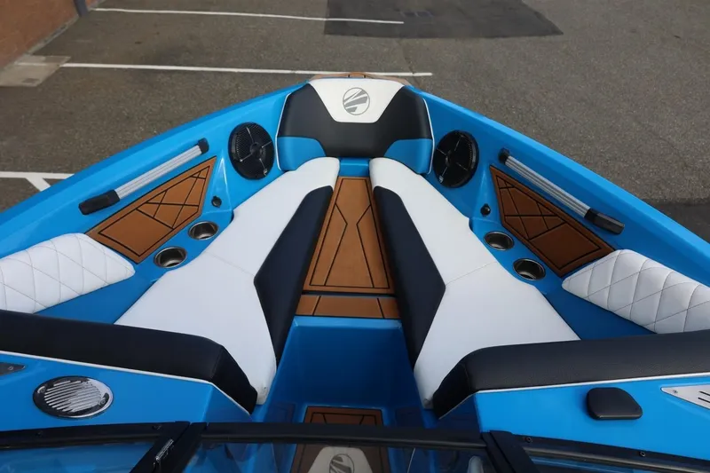 Slide: The Image of 2022 Tigé Z3 boat interior with blue and white seating, cup holders, and speakers. - 46