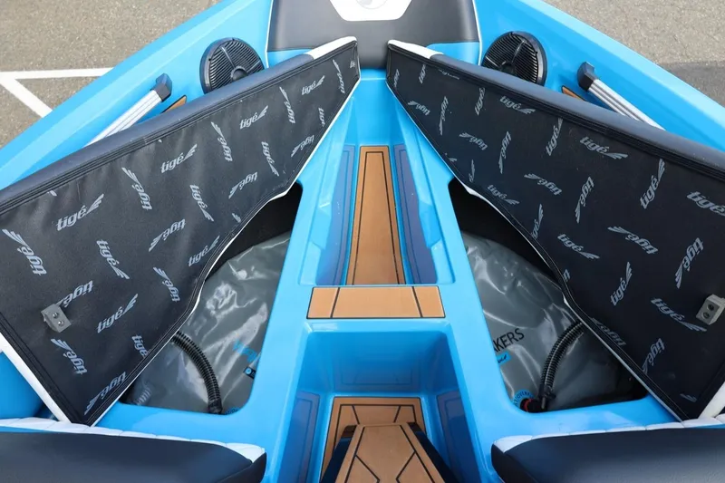 Slide: The Image of 2022 Tigé Z3 boat interior with open storage compartments and branded covers. - 49