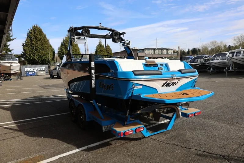 Slide: The Image of 2022 Tigé Z3 boat in a parking lot, showcasing sleek design and vibrant blue color. - 9