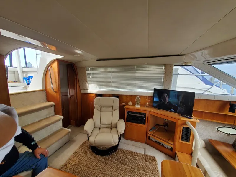 Slide: The Image of Interior of 2000 Silverton 422 Motor Yacht featuring cozy living area. - 10