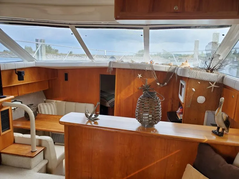 Slide: The Image of Interior of a 2000 Silverton 422 Motor Yacht with wooden furnishings and decorations. - 11