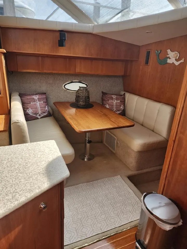 Slide: The Image of Interior of 2000 Silverton 422 Motor Yacht with cozy seating area. - 15