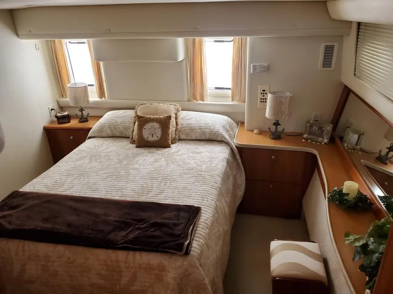 Slide: The Image of Interior of 2000 Silverton 422 Motor Yacht featuring cozy bedroom. - 17