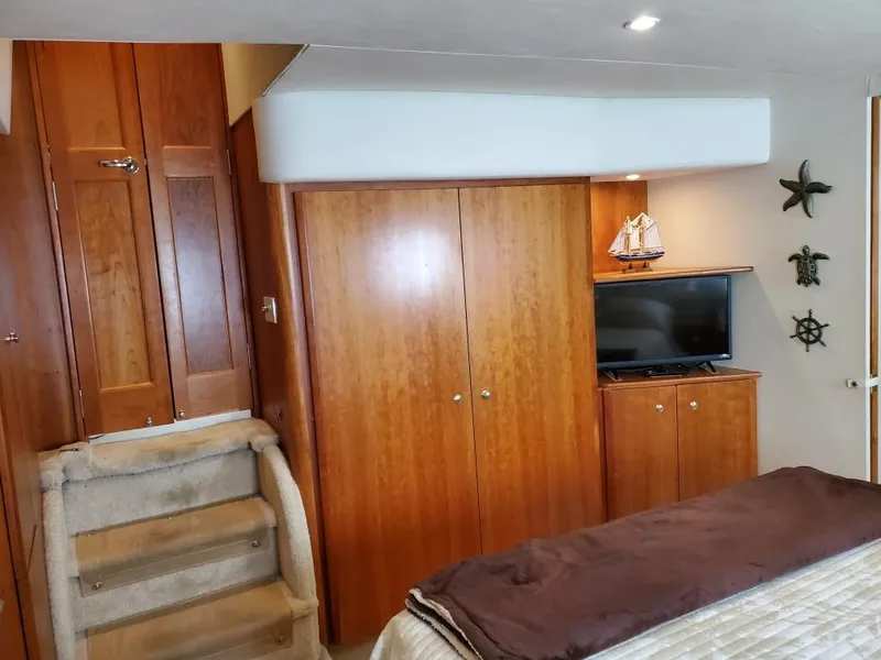 Slide: The Image of Interior of 2000 Silverton 422 Motor Yacht with wooden cabinets. - 18