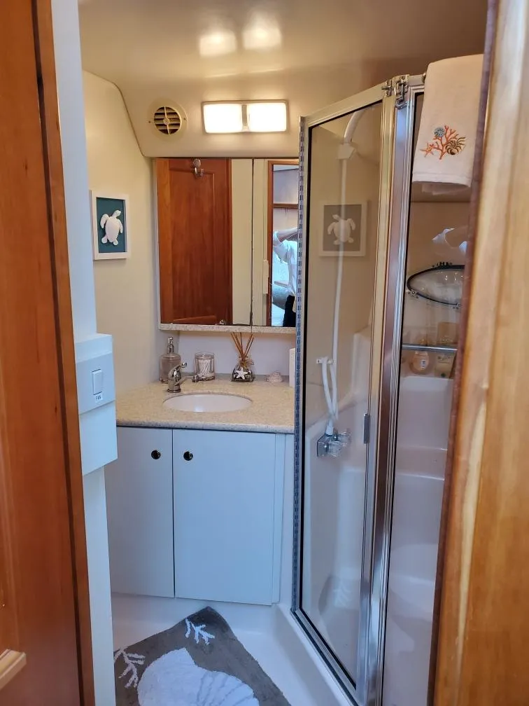 Slide: The Image of Bathroom of 2000 Silverton 422 Motor Yacht with shower and sink. - 22