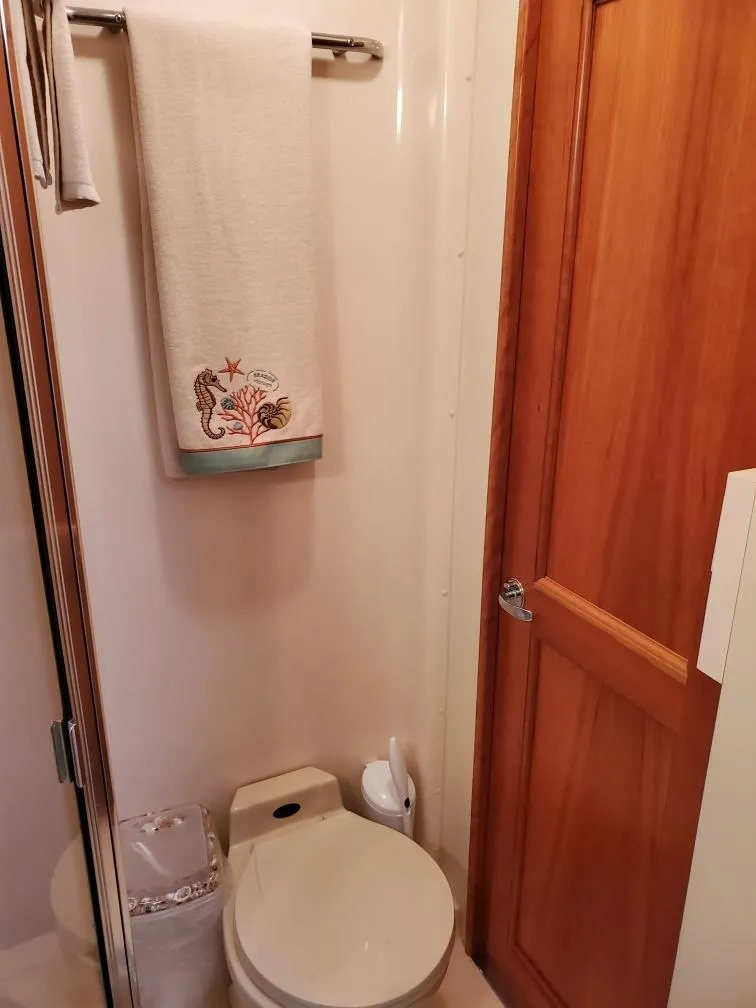 Slide: The Image of 2000 Silverton 422 Motor Yacht bathroom with towel and toilet. - 24
