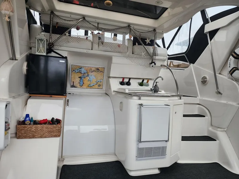 Slide: The Image of Interior of a 2000 Silverton 422 Motor Yacht with kitchenette and stairs. - 5