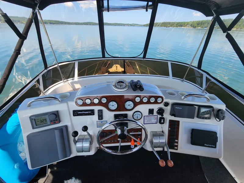 Slide: The Image of Helm of 2000 Silverton 422 Motor Yacht on calm waters. - 8