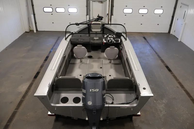 Slide: The Image of 2015 Starcraft Super Fisherman 186 boat in a garage, featuring Yamaha 150 engine. - 10