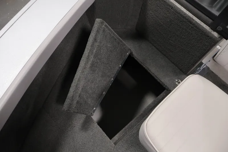 Slide: The Image of 2015 Starcraft Super Fisherman 186 boat interior storage compartment with open hatch. - 18