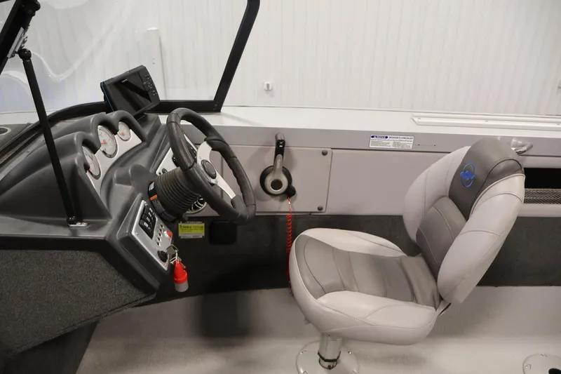 Slide: The Image of 2015 Starcraft Super Fisherman 186 boat interior with steering wheel and captain's chair. - 19