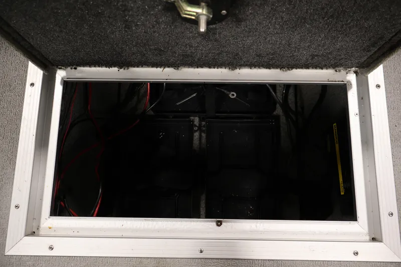Slide: The Image of Battery compartment of 2015 Starcraft Super Fisherman 186 boat, showing wiring and storage. - 34