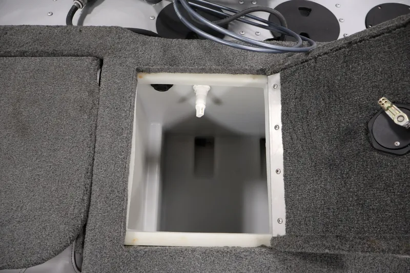 Slide: The Image of 2015 Starcraft Super Fisherman 186 boat storage compartment with gray carpeted interior. - 38