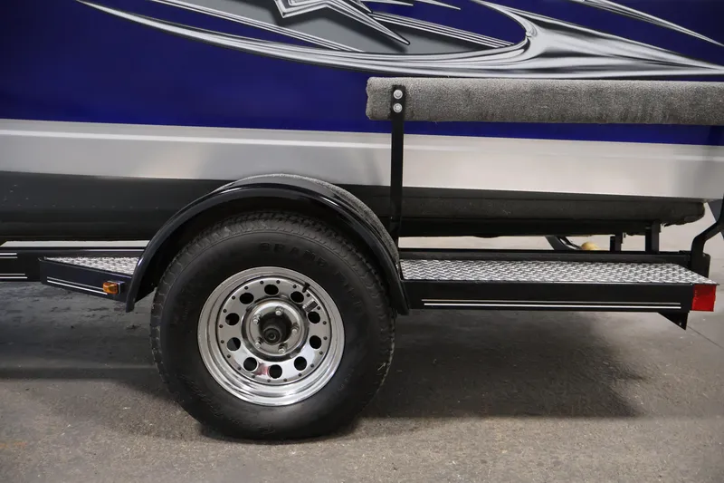Slide: The Image of 2015 Starcraft Super Fisherman 186 trailer wheel and side view, featuring blue and silver design. - 47