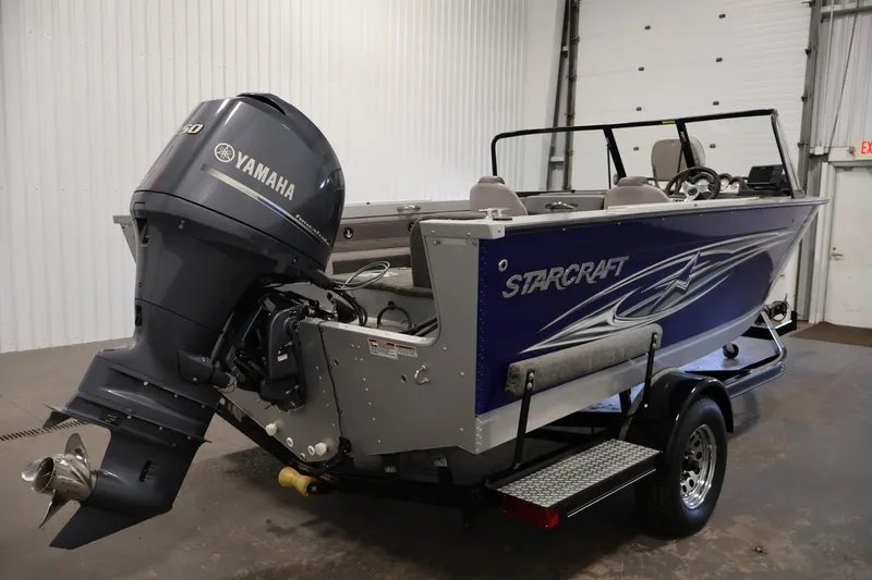 Slide: The Image of 2015 Starcraft Super Fisherman 186 boat with Yamaha outboard motor in a garage. - 5