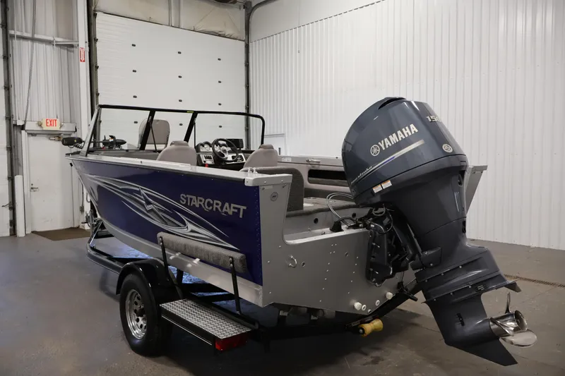 Slide: The Image of 2015 Starcraft Super Fisherman 186 boat with Yamaha outboard motor in a garage. - 7