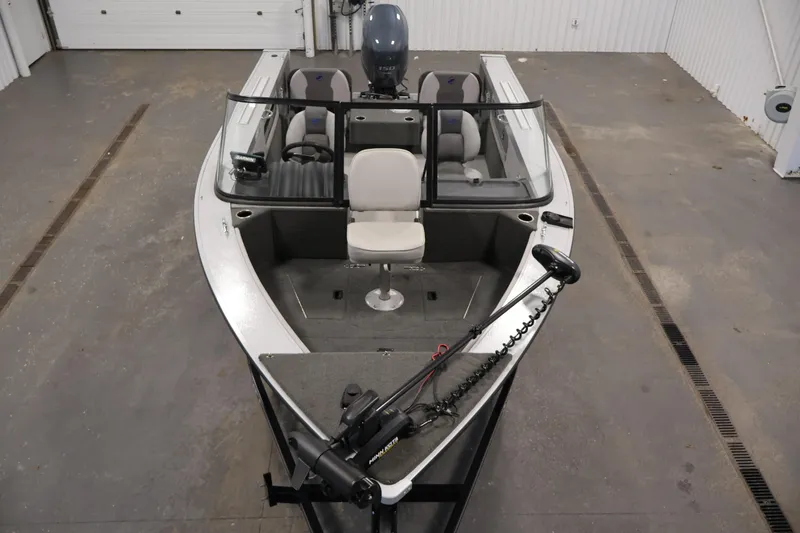 Slide: The Image of 2015 Starcraft Super Fisherman 186 boat in a garage, featuring seating and fishing equipment. - 9