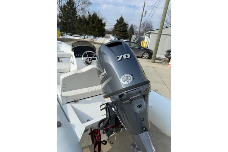 Slide: The Image of 2026 Novurania DL 430 boat with Yamaha 70 outboard motor in a driveway. - 6