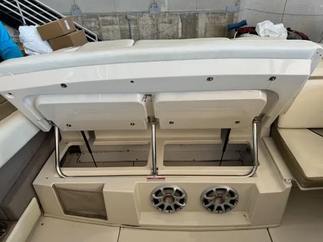 Slide: The Image of 2007 Sea Ray 230 Select boat with open storage compartment and dual speakers. - 11
