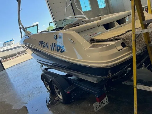Slide: The Image of 2007 Sea Ray 230 Select boat named Open Wide on a trailer in a garage. - 13